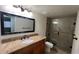 Bathroom with granite countertop vanity and tiled shower at 150 El Dorado # 109, Winter Haven, FL 33884
