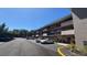 Exterior view of condo complex with parking and well maintained mature landscaping at 150 El Dorado # 109, Winter Haven, FL 33884