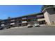 Exterior view of multi-story building with car parking in a well-maintained complex at 150 El Dorado # 109, Winter Haven, FL 33884