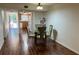 Dining area adjacent to kitchen featuring wood floors and natural light at 150 El Dorado # 109, Winter Haven, FL 33884