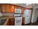 Updated kitchen featuring stainless steel appliances, granite counters, and wood-look flooring at 150 El Dorado # 109, Winter Haven, FL 33884