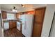 Updated kitchen with stainless steel appliances, granite countertops, and wood floors at 150 El Dorado # 109, Winter Haven, FL 33884