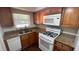 Bright kitchen featuring stainless steel appliances and granite countertops at 150 El Dorado # 109, Winter Haven, FL 33884