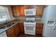 Kitchen with granite countertops, white appliances, and updated cabinetry at 150 El Dorado # 109, Winter Haven, FL 33884