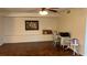 Well-lit living room with wood flooring, desk area and neutral colored walls at 150 El Dorado # 109, Winter Haven, FL 33884