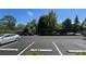 View of covered parking area with parking spots and mature landscaping at 150 El Dorado # 109, Winter Haven, FL 33884