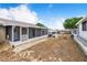 Spacious backyard showing the patio area, screen room, and neighboring patios and homes at 151 Winter Ridge Dr # 151, Winter Haven, FL 33881