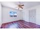 This bedroom is bright and airy with wood floors and a closet at 151 Winter Ridge Dr # 151, Winter Haven, FL 33881