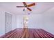 Bright bedroom featuring wood floors, a ceiling fan, and a closet for storage at 151 Winter Ridge Dr # 151, Winter Haven, FL 33881