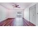 This bedroom features wood floors, closet space, and a sliding door to the outside at 151 Winter Ridge Dr # 151, Winter Haven, FL 33881