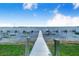 Beautiful view of a long wooden dock leading into the serene lake at 151 Winter Ridge Dr # 151, Winter Haven, FL 33881