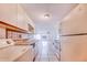 Bright eat-in kitchen featuring white appliances, tile floors, and plenty of natural light at 151 Winter Ridge Dr # 151, Winter Haven, FL 33881