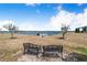 Inviting lake view with seating, small trees, and a dock at 151 Winter Ridge Dr # 151, Winter Haven, FL 33881