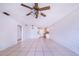 Spacious living room with tile floors, a ceiling fan, and an open layout to the kitchen at 151 Winter Ridge Dr # 151, Winter Haven, FL 33881