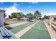 Well-maintained shuffleboard courts featuring green and white surfaces and shaded seating areas at 151 Winter Ridge Dr # 151, Winter Haven, FL 33881