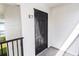 Close up of apartment E7 featuring a black door and white facade at 1550 11Th Ne St # E7, Winter Haven, FL 33881