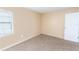 Well-lit bedroom with plush carpeting, window, and soft neutral color palette at 1550 11Th Ne St # E7, Winter Haven, FL 33881