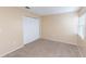A cozy bedroom featuring carpet, a large closet, and soft, neutral color palette at 1550 11Th Ne St # E7, Winter Haven, FL 33881