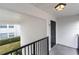 Exterior view of front door for unit E7 with black railing at 1550 11Th Ne St # E7, Winter Haven, FL 33881