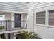 Exterior shot of the unit E7 front door, balcony, and front window at 1550 11Th Ne St # E7, Winter Haven, FL 33881