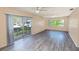 Bright living room featuring sliding doors to the balcony and wood-look flooring at 1550 11Th Ne St # E7, Winter Haven, FL 33881