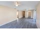 Open-concept living room with wood-look floors, neutral walls and access to kitchen at 1550 11Th Ne St # E7, Winter Haven, FL 33881