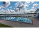 Community pool overlooking the lake, featuring ample seating and an American flag at 1550 11Th Ne St # E7, Winter Haven, FL 33881
