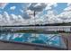 Inviting community pool offers a lake view, an American flag, and comfortable seating at 1550 11Th Ne St # E7, Winter Haven, FL 33881
