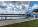 The community pool area features a pool house and comfortable seating by the lake at 1550 11Th Ne St # E7, Winter Haven, FL 33881
