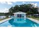 The community pool area has a pool house, seating, and parking at 1550 11Th Ne St # E7, Winter Haven, FL 33881