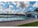 The pool area includes a pool house, lounge chairs, and a serene view at 1550 11Th Ne St # E7, Winter Haven, FL 33881