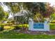 Lake Buckeye condominium community sign is surrounded by mature trees and landscaping at 1550 11Th Ne St # E7, Winter Haven, FL 33881