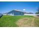 Expansive backyard with well-kept grass, a white fence, and lush greenery, perfect for outdoor activities at 157 Walkers Point Dr, Auburndale, FL 33823