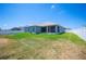 Wide backyard showcases vibrant green grass, a white fence, and a screened patio area, perfect for relaxation at 157 Walkers Point Dr, Auburndale, FL 33823