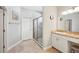 Bright bathroom featuring tile floors, glass-enclosed shower, and single sink vanity at 157 Walkers Point Dr, Auburndale, FL 33823