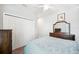 This comfortable bedroom features a ceiling fan, closet and wooden dresser at 157 Walkers Point Dr, Auburndale, FL 33823