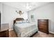 Comfortable bedroom features a ceiling fan, window, and wooden dresser at 157 Walkers Point Dr, Auburndale, FL 33823