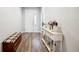 Bright entryway with hardwood floors, a decorative console table, and a view into the well-lit interior of the home at 157 Walkers Point Dr, Auburndale, FL 33823