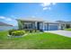 Inviting single-story home with vibrant green lawn, decorative landscaping, and a serene residential setting on a sunny day at 157 Walkers Point Dr, Auburndale, FL 33823