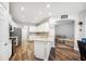 Modern kitchen with white cabinetry, stainless steel appliances, and an open layout seamlessly connected to the living area at 157 Walkers Point Dr, Auburndale, FL 33823