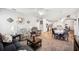 Bright and open living room featuring carpeted flooring, neutral tones and connected to dining area at 157 Walkers Point Dr, Auburndale, FL 33823