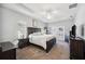 Large main bedroom featuring carpet flooring, tray ceiling, with access to the backyard at 157 Walkers Point Dr, Auburndale, FL 33823