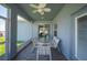 Covered patio featuring ceiling fan, outdoor seating, and access to the backyard at 157 Walkers Point Dr, Auburndale, FL 33823