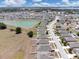 Expansive aerial view of a residential community, featuring a central pond and well-maintained homes under a sunny sky at 180 Grove Branch Rd, Winter Haven, FL 33880