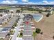 An aerial view pinpoints a home in a residential neighborhood with a pond at 180 Grove Branch Rd, Winter Haven, FL 33880