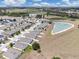 Wide aerial view showcases a residential neighborhood next to a scenic pond at 180 Grove Branch Rd, Winter Haven, FL 33880