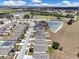An aerial view of the residential neighborhood showcasing its layout and a tranquil pond at 180 Grove Branch Rd, Winter Haven, FL 33880