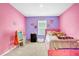 Cute bedroom features pink and purple colors and window at 180 Grove Branch Rd, Winter Haven, FL 33880