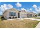 Single-story home featuring manicured landscaping and a two-car garage at 180 Grove Branch Rd, Winter Haven, FL 33880
