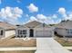 Well-kept single-story home with landscaped front yard and attached garage at 180 Grove Branch Rd, Winter Haven, FL 33880